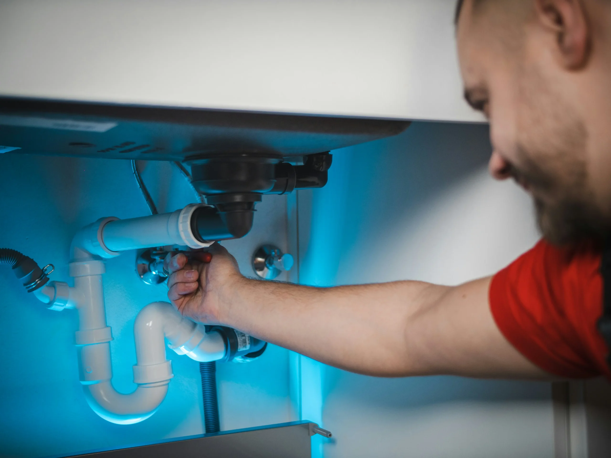 Plumber working on plumbing fixtures